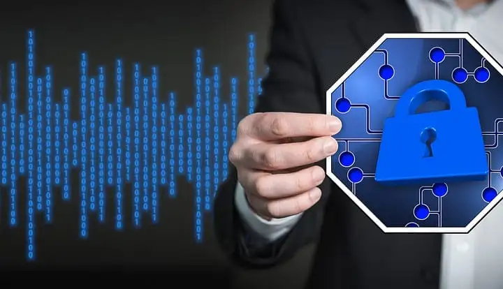 Hand in a suit holding a blue padlock icon against a background of binary digits