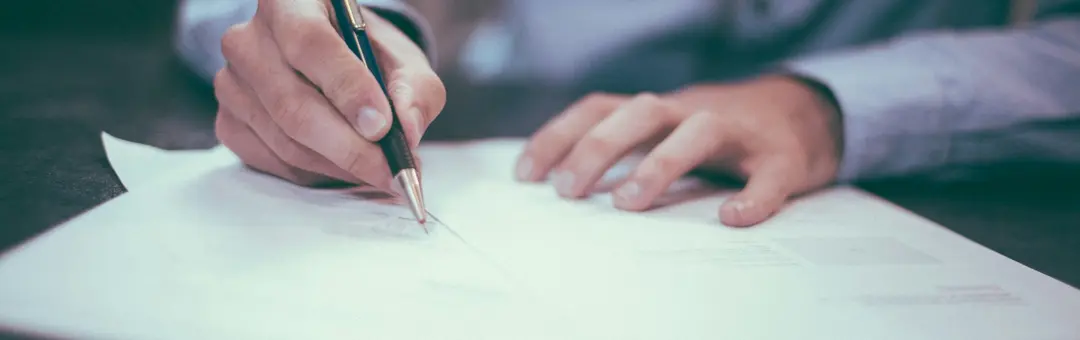 Man signing insurance policy.