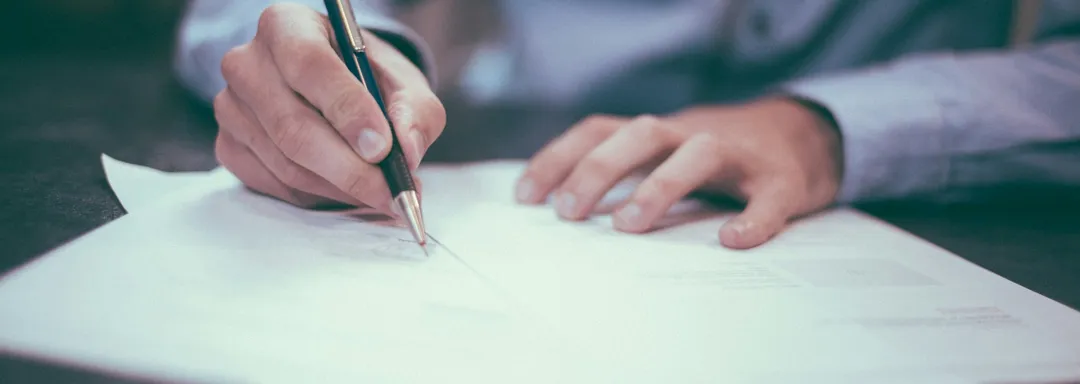 Man signing insurance policy.