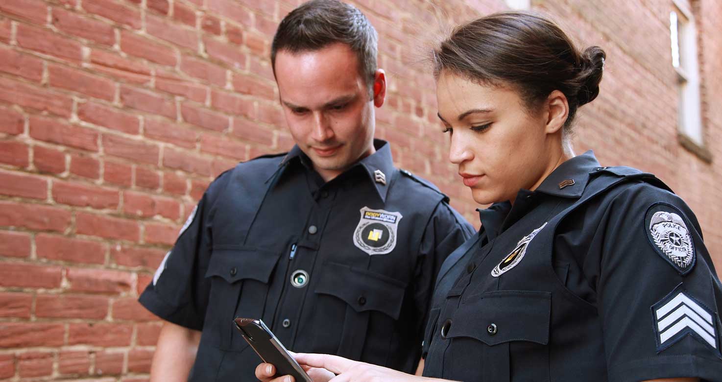 Security Officers checking a mobile phone.